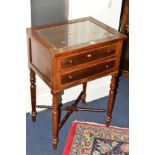 AN EDWARDIAN MAHOGANY SIDE TABLE with two drawers on turned legs united by a cross stretcher,