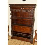A VICTORIAN OAK OPEN BOOKCASE, with heavily carved masks, grapes and foliage, two drawers with lions