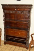 A VICTORIAN OAK OPEN BOOKCASE, with heavily carved masks, grapes and foliage, two drawers with lions