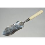 A 19TH CENTURY WHITE METAL IVORY HANDLED FISH SLICE, engraved blade, shell and scroll decoration,