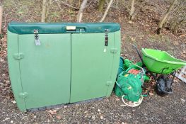 A LARGE GREEN GARDEN STORAGE BOX, two hose reels with another, plastic wheel barrow and a smaller