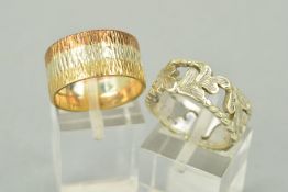 TWO LATE 20TH CENTURY 9CT GOLD BAND RINGS, a three colour gold bark finish wedding band, measuring