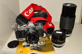 A CANON AV-1 FILM SLR CAMERA, fitted with a Sigma 28mm f2.8 lens, a Canon FD 50mm f1.8, a Vivitar