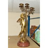 A LARGE BRASS CHERUB, holding a three light candelabra, on plinth, approximate total height 69cm