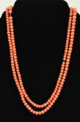 AN EARLY 20TH CENTURY CORAL BEAD NECKLACE, the graduated beads measuring 3mm to 7mm, to the spring