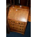 A REPRODUCTION WALNUT LADIES FALL FRONT BUREAU with four drawers, width 54cm x depth 42cm x height