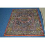 A 20TH CENTURY CAUCASIAN STYLE RUG, red, green and dark blue ground, foliate design and multi