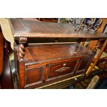 AN EARLY 20TH CENTURY OAK MONKS BENCH with a panelled front and hinged top