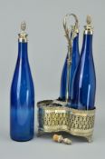 A PLATED THREE BOTTLE TANTALUS with trefoil shaped base and central handle and three blue glass