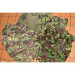 A GREEN CANVAS ARMY ISSUE BAG, containing four pairs of camo trousers, combat NATO DPM and four