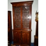 A TALL LATE 19TH/EARLY 20TH CENTURY MAHOGANY AND BANDED BOOKCASE, the later top with double astragal