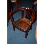 AN EDWARDIAN MAHOGANY TUB CHAIR with brown leather upholstery (sd)
