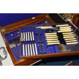 AN EDWARDIAN OAK CASED CANTEEN OF SILVER PLATED OLD ENGLISH PATTERN CUTLERY, marker William Page,