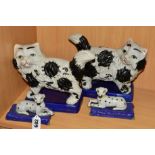 A PAIR OF STAFFORDSHIRE STYLE DOGS, lying on cushion, approximate length 13cm together with a pair