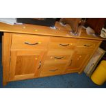 A MODERN LIGHT OAK SIDEBOARD with five various drawers and double cupboard doors, width 138cm x