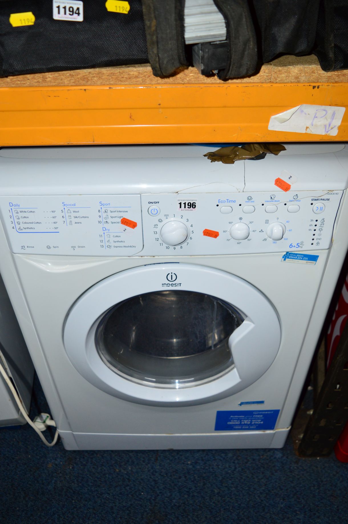 AN INDESIT WASHING MACHINE (damage to front control panel), together with a Russell Hobbs