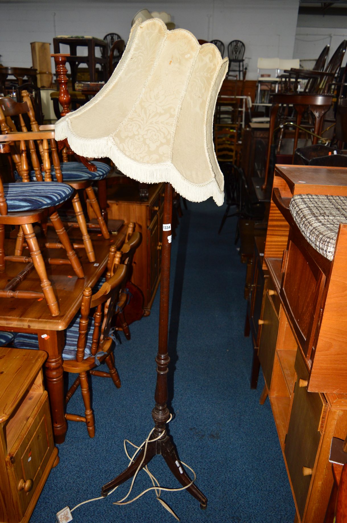 AN EDWARDIAN MAHOGANY TRIPOD STANDARD LAMP with a shade