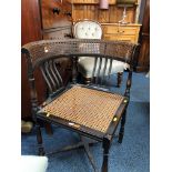 AN EDWARDIAN OAK CORNER CHAIR with caned seat and back, together with an Edwardian piano stool (2)