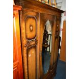 AN OAK BARLEY TWIST TWO PIECE BEDROOM SUITE, comprising of a single mirror door wardrobe above a