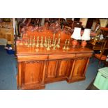 A VICTORIAN WALNUT SIDEBOARD, the raised back with carved foliate detail above three various drawers