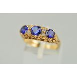 A 9CT GOLD GEM RING, designed as three circular sapphires interspaced by circular colourless