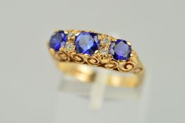A 9CT GOLD GEM RING, designed as three circular sapphires interspaced by circular colourless