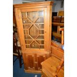 A PINE GLAZED FLOOR STANDING CORNER CUPBOARD, width 83cm x depth 35cm x height 184cm, together