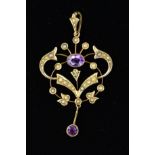 AN EDWARDIAN AMETHYST AND SPLIT PEARL PENDANT of openwork scrolling design set with split pearls,