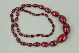 A RED PLASTIC BEAD NECKLACE, the graduated necklace comprising of forty three shape beads