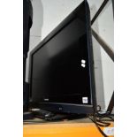 A PANASONIC 32' FSTV (1 remote) and a black glass TV stand (spares or repairs)