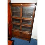 AN EARLY 20TH CENTURY OAK FOUR SECTION BOOKCASE, the upper three sections with glazed double doors