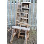 A PAIR OF WOODEN TRESSLE STANDS, another single smaller one, step ladders and work horse (5)