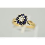 A 9CT GOLD SAPPHIRE AND DIAMOND CLUSTER RING, a central single cut diamond within an illusion