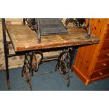 A SINGER TREADLE SEWING MACHINE BASE with a later added wooden top, together with a beech display