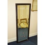 AN EARLY 20TH CENTURY RECTANGULAR OAK BEVELLED EDGE WALL MIRROR with geometric detail, 138cm x 50cm