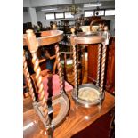 A CIRCULAR OAK BARLEY TWIST UMBRELLA STAND and a similar umbrella stand (2)