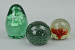 A GREEN GLASS DUMPY WEIGHT with floral vase inclusion and two other glass paperweights (3)