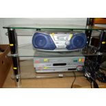 A GLASS TV STAND, A Pansonic stereo, a Phillips VHS player and a Sharp DVD player (4)