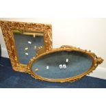 A GILTWOOD AND FOLIATE FRAMED WALL MIRROR together with an oval wall mirror (2)