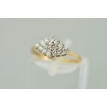 A 9CT GOLD CLUSTER RING designed as a diamond shaped tiered cluster of circular cubic zirconias,