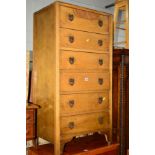 A TALL OAK CHEST OF SIX DRAWERS