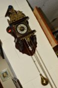 A DUTCH WALL CLOCK, with Roman numeral dial and brass motifs, with weights (some damage to wood at