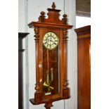 A VICTORIAN WALNUT VIENNA EIGHT DAY WALL CLOCK, the enamel dial with Roman numerals and seconds dial