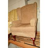 A MODERN OATMEAL UPHOLSTERED WINGBACK ARMCHAIR