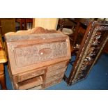 AN ORIENTAL HEAVILY CARVED HARDWOOD FALL FRONT BUREAU, the interior containing various drawers and