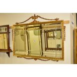 A GILTWOOD FRAMED GREEK STYLE BEVELLED EDGE WALL MIRROR, 97cm x 77cm