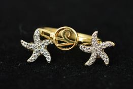A 9CT GOLD RING AND A PAIR OF EAR STUDS, the central circular panel with an openwork design and