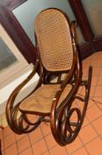 AN EARLY 20TH CENTURY OAK BENTWOOD ROCKING CHAIR with cane seat and back