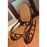 AN EARLY 20TH CENTURY OAK BENTWOOD ROCKING CHAIR with cane seat and back