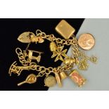 A MID TO LATE 20TH CENTURY CHARM BRACELET, plain polished curb links fitted to a padlock and